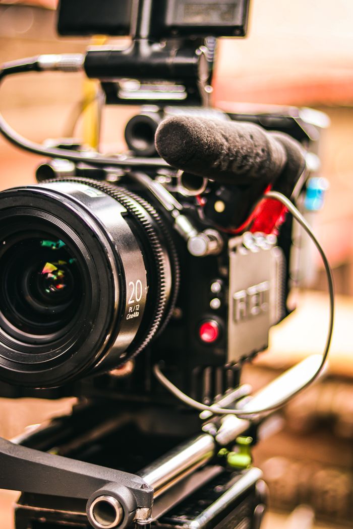 Services Detailed view of a professional video camera setup with attached microphone for videography.